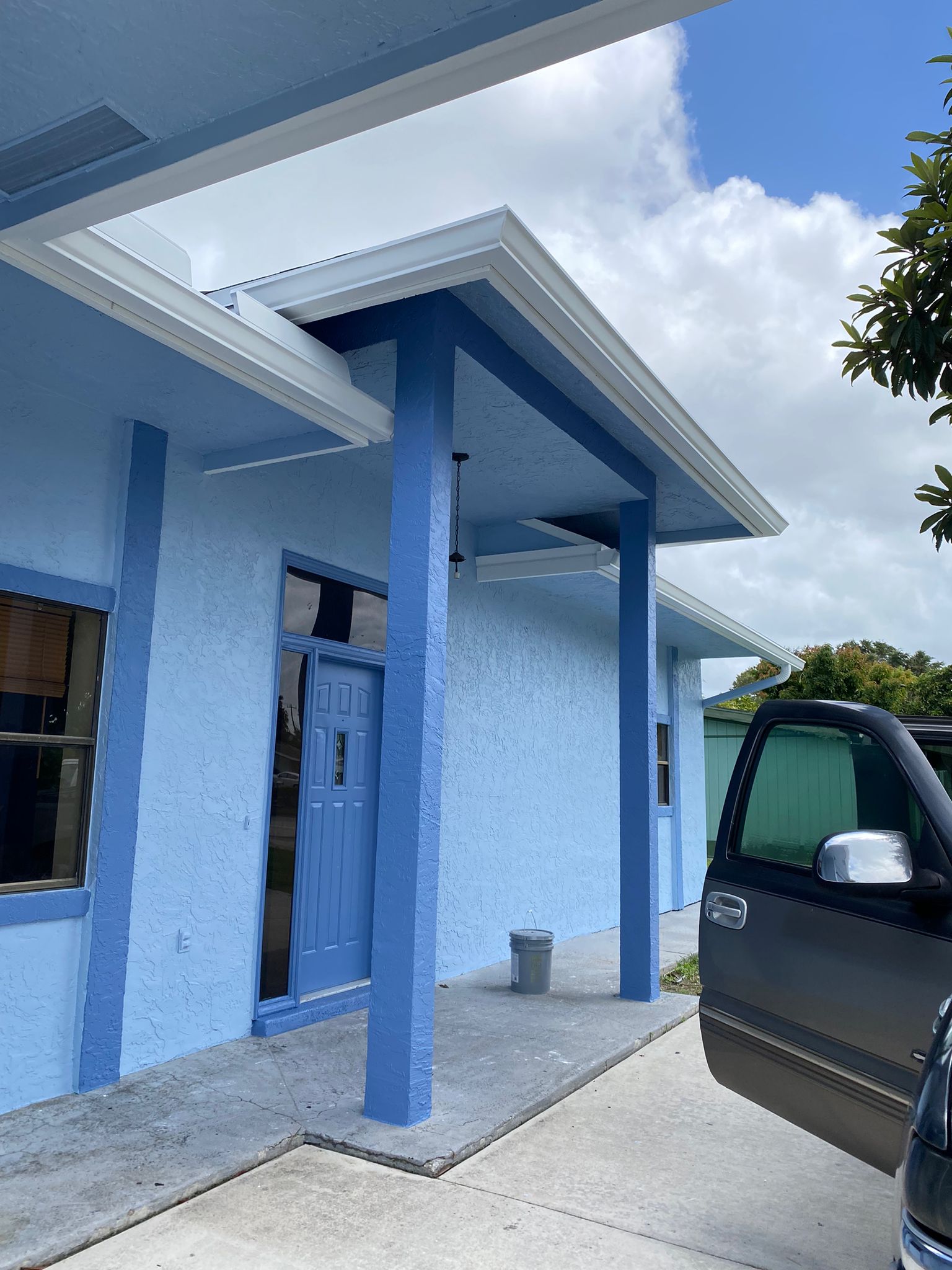 Freshly painted blue commercial building entrance with columns