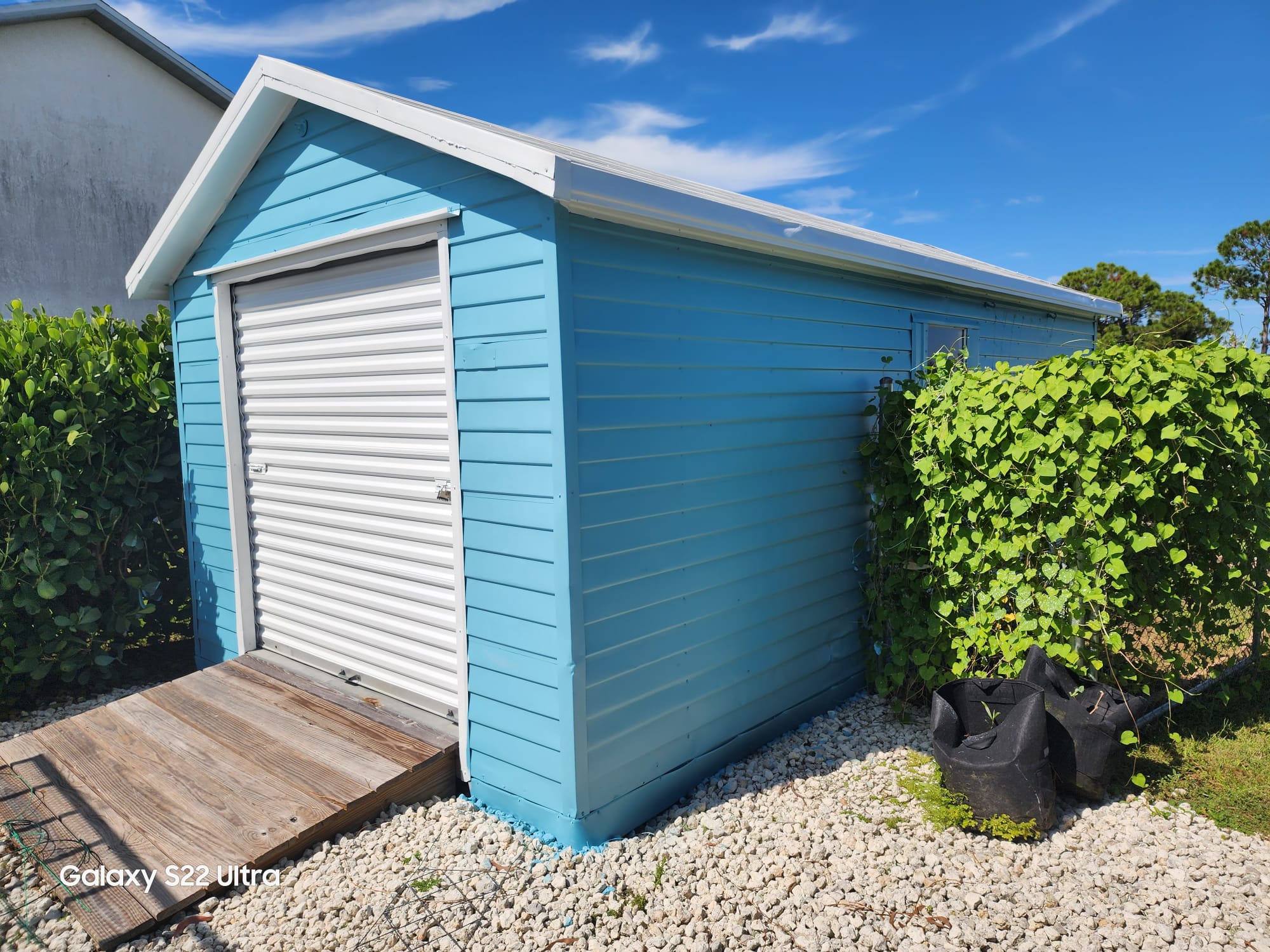 Clean light-blue outbuilding with bright white trim
