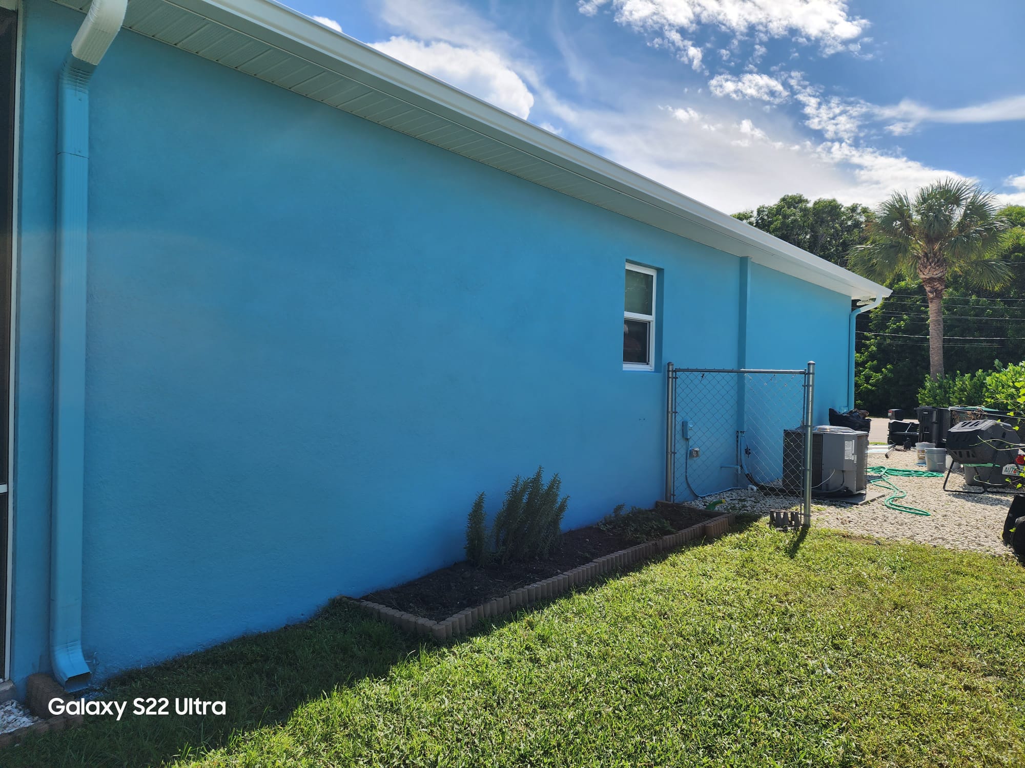 Blue stucco exterior wall free of mold and mildew