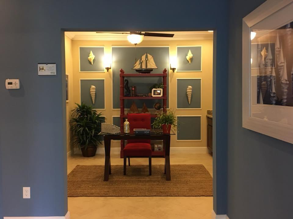Blue painted home office nook with red desk