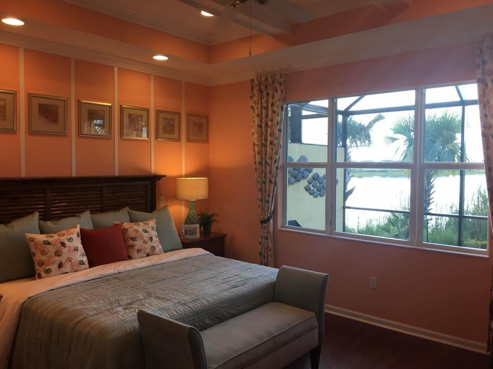 Coral painted master bedroom with lake view