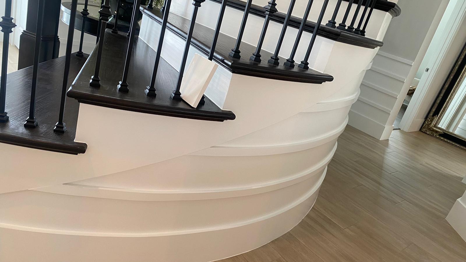 Elegant curved staircase with white risers and dark treads