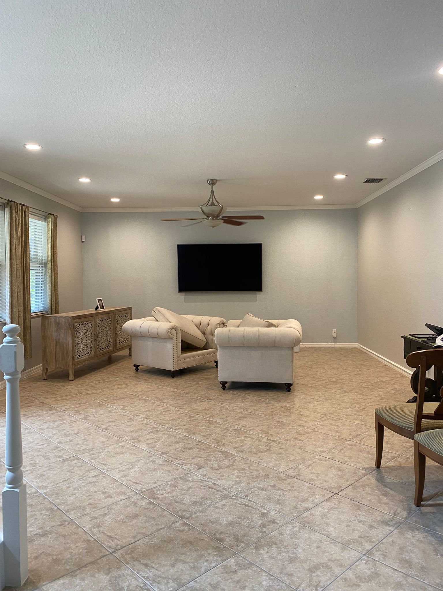 Large gray living room with crown molding