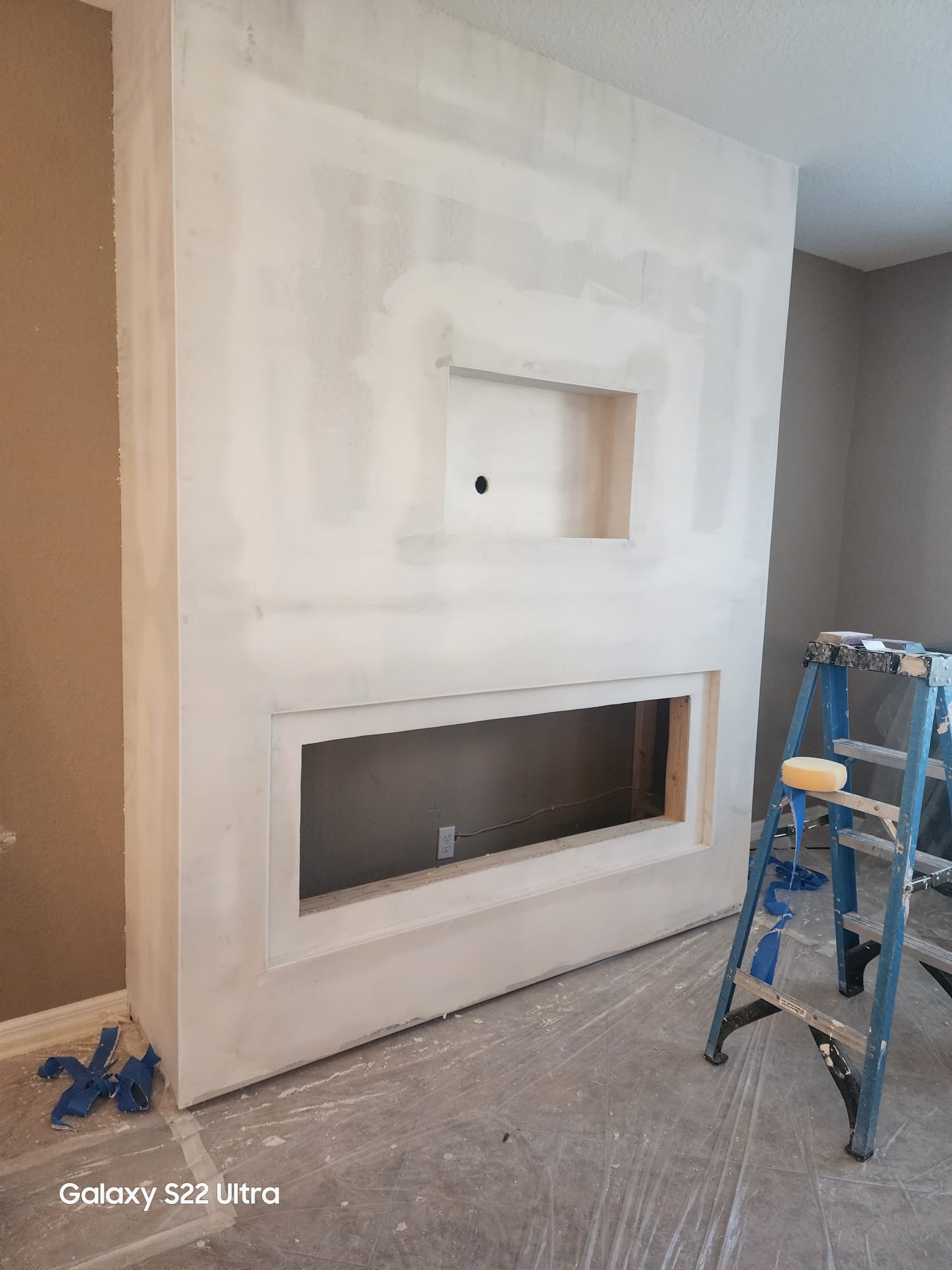 Drywall fireplace feature wall being finished