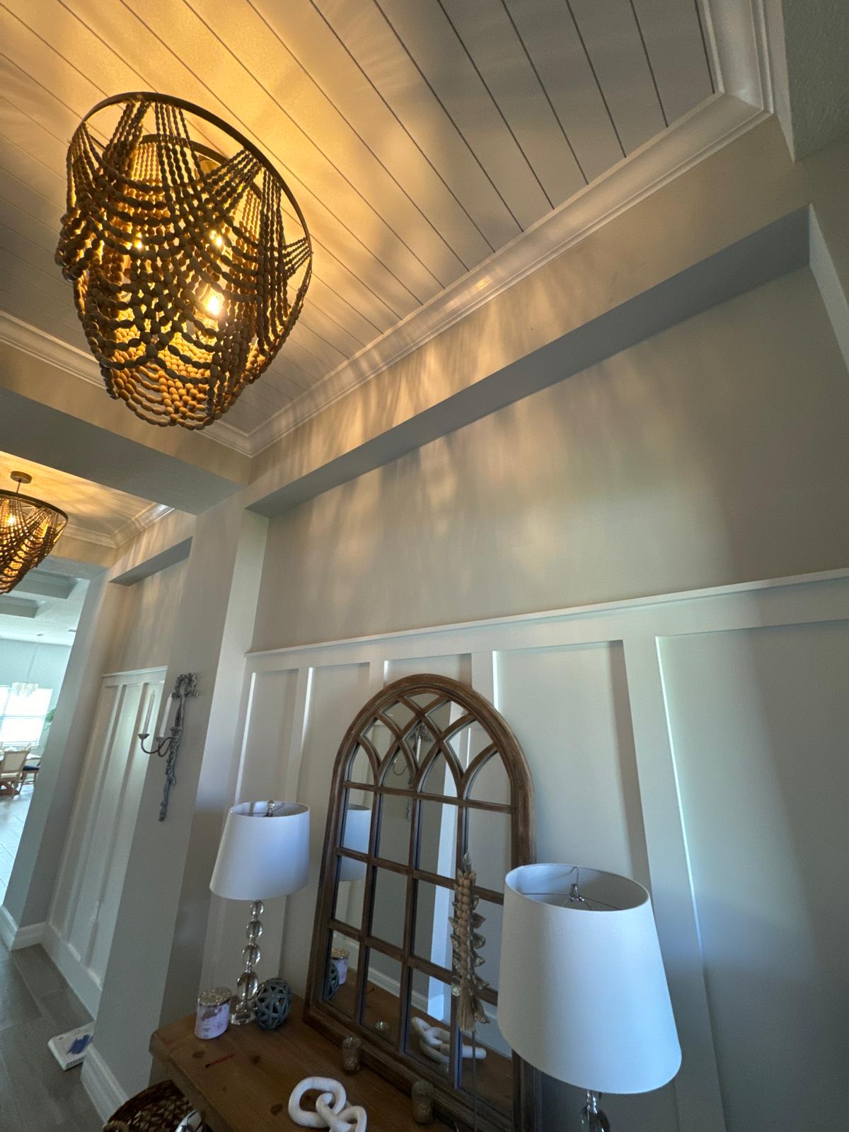 Entryway with white shiplap ceiling and chandelier