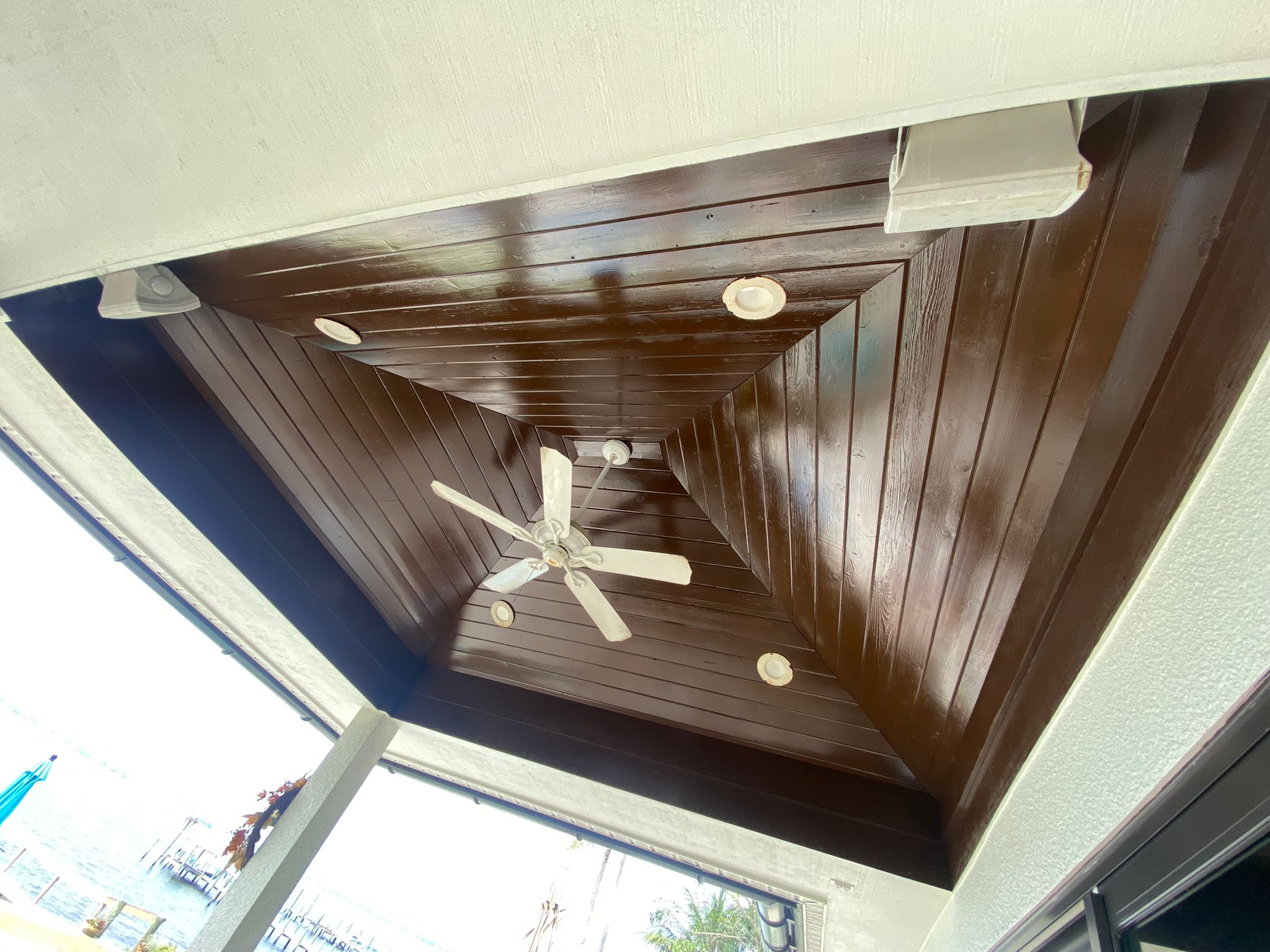 Stained wood tongue and groove vaulted patio ceiling