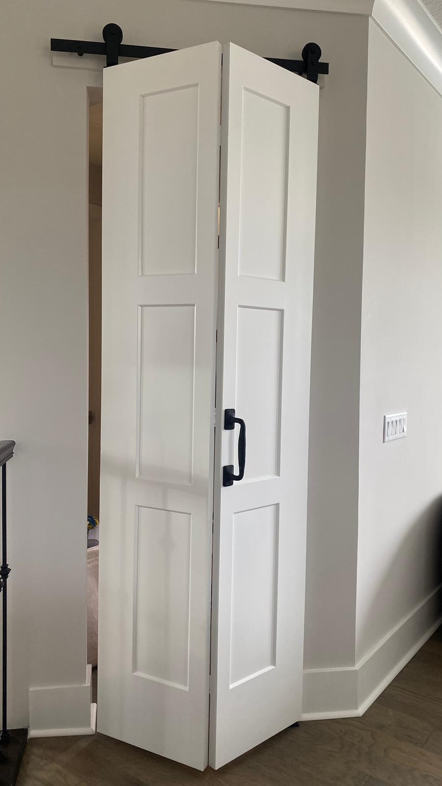 White bifold barn door with smooth painted finish